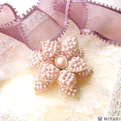 Flower brooch made of Miyuki baroque seed beads.